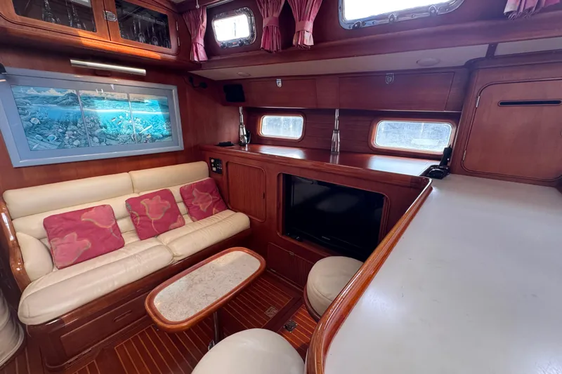 Entertainer Yacht Photos Pics Luxurious 1989 Little Harbor Sloop 58' interior with cozy seating and elegant wood finishes.