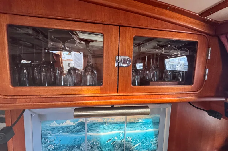 Entertainer Yacht Photos Pics Wooden cabinet with glassware in a 1989 Little Harbor Sloop - 58' yacht interior.