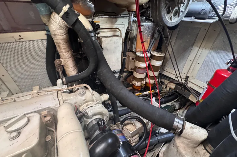 Entertainer Yacht Photos Pics Engine room of a 1989 Little Harbor Sloop 58' with visible components and hoses.