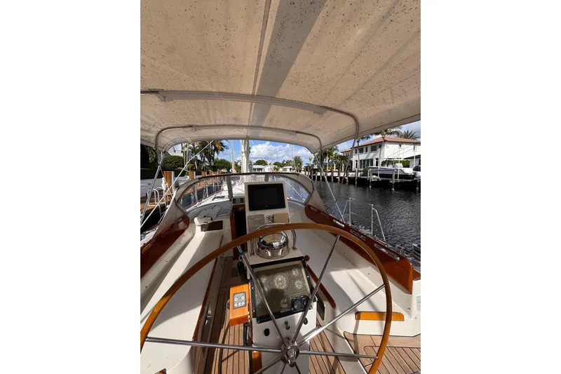 Entertainer Yacht Photos Pics Cockpit view of 1989 Little Harbor Sloop 58' with steering wheel and navigation equipment.