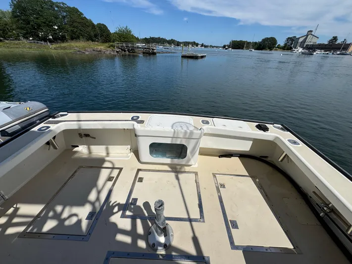 Chilla Yacht Photos Pics Northern Bay 36 boat deck, 2009 model, overlooking serene waters and lush greenery.