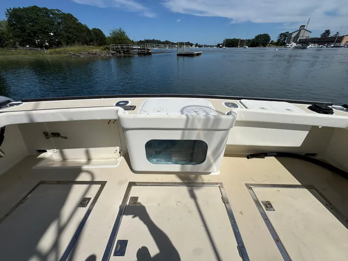 Chilla Yacht Photos Pics Northern Bay 36 boat deck, 2009 model, overlooking serene waters and distant shoreline.