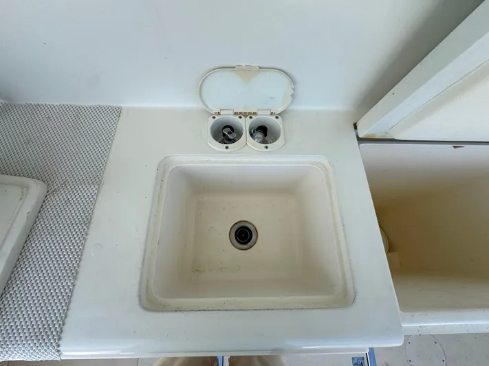 Chilla Yacht Photos Pics White sink and storage area on a 2009 Northern Bay 36 boat.