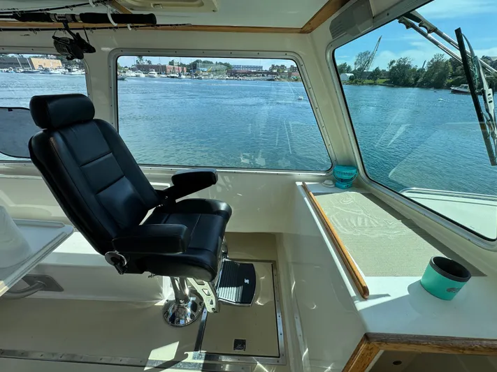 Chilla Yacht Photos Pics Interior of 2009 Northern Bay 36 boat with captain's chair and scenic water view.