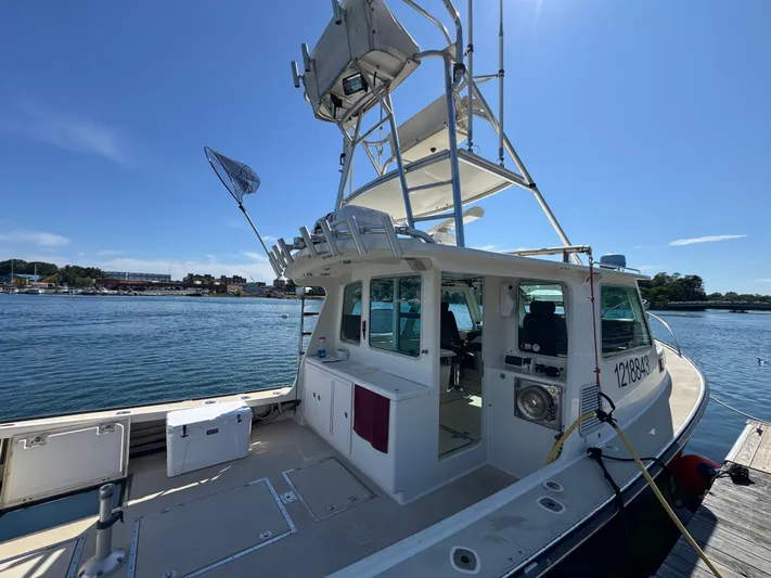 Chilla Yacht Photos Pics 2009 Northern Bay 36 boat docked, featuring a spacious deck and tower under clear blue skies.