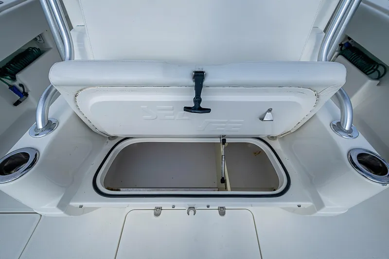Fishy Business Yacht Photos Pics 2014 SeaVee 390B boat storage compartment with open hatch and cup holders.