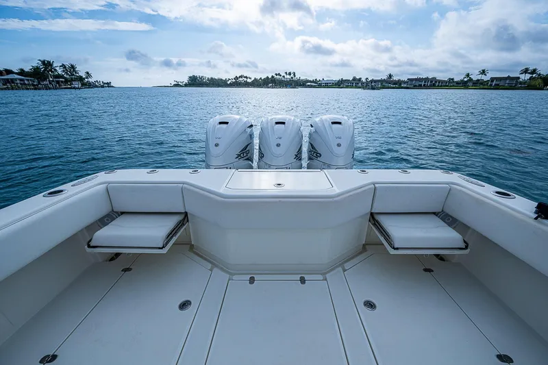 Fishy Business Yacht Photos Pics 2014 SeaVee 390B boat with triple engines on calm water, clear sky.