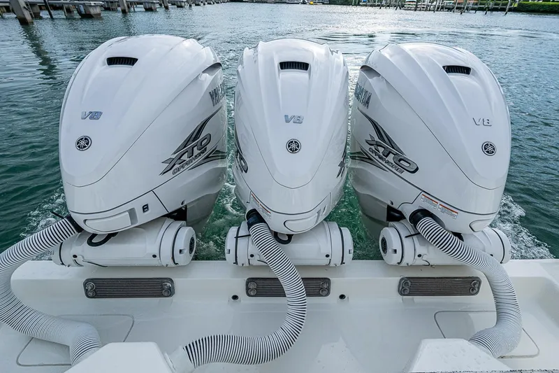 Fishy Business Yacht Photos Pics Triple Yamaha V8 outboard engines on a 2014 SeaVee 390B boat, docked in a marina.