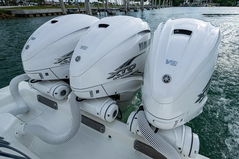 Fishy Business Yacht Photos Pics Triple Yamaha V8 outboard engines on a 2014 SeaVee 390B boat, docked on water.
