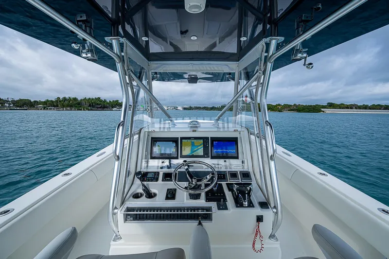 Fishy Business Yacht Photos Pics 2014 SeaVee 390B boat cockpit with advanced navigation system on calm water.