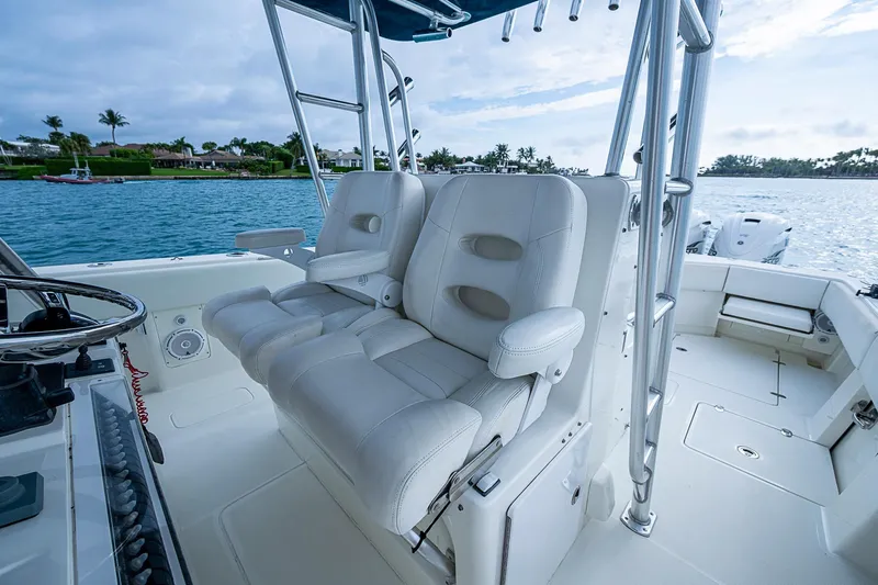 Fishy Business Yacht Photos Pics 2014 SeaVee 390B boat interior with white seating and steering wheel, on calm water.