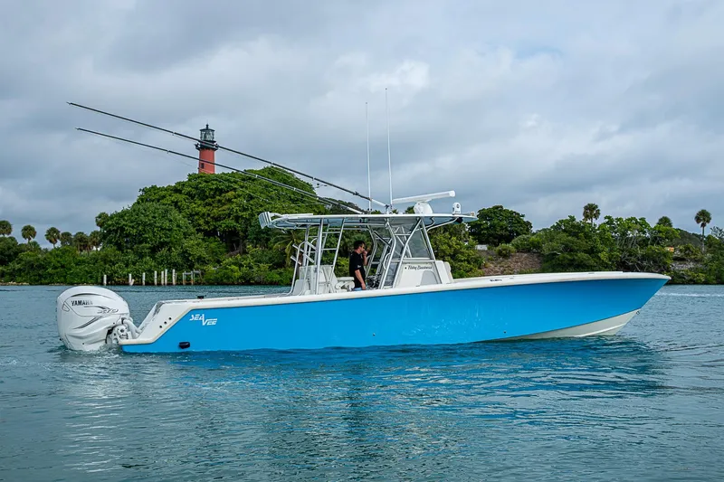 Fishy Business Yacht Photos Pics 2014 SeaVee 390B boat with Yamaha engines on calm water, lighthouse in background.