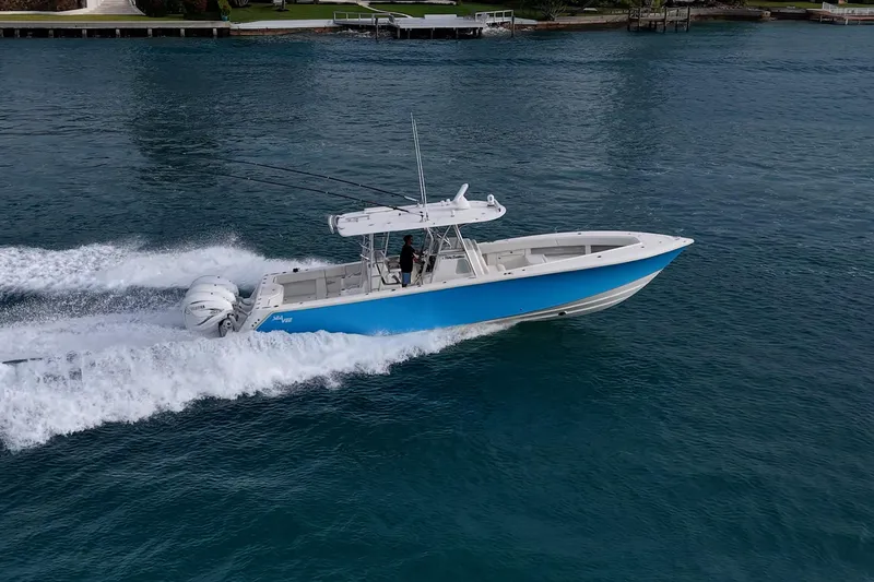 Fishy Business Yacht Photos Pics 2014 SeaVee 390B boat cruising on blue water, side view.