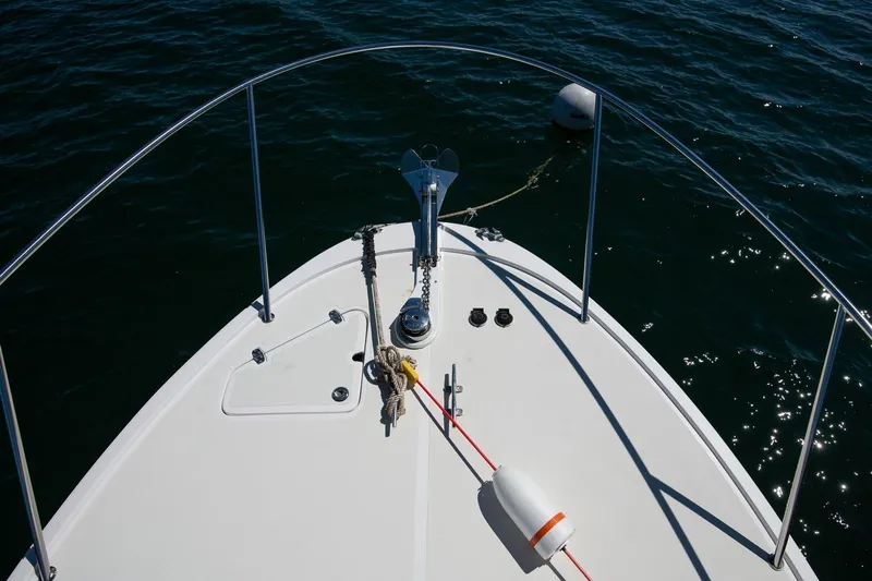 Robin Yacht Photos Pics Bow of 2005 Hunt Yachts Surfhunter 29 on water, featuring anchor and railings.