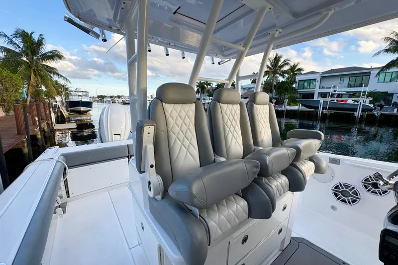  Yacht Photos Pics 2021 Everglades 335 Center Console boat with luxurious seating, docked by waterfront homes.