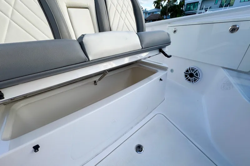  Yacht Photos Pics 2021 Everglades 335 Center Console boat interior with open storage compartment and speaker.