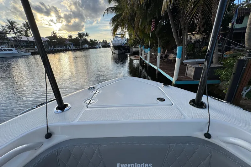  Yacht Photos Pics 2021 Everglades 335 Center Console boat docked by a scenic waterfront.