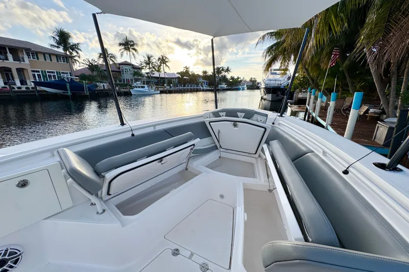  Yacht Photos Pics 2021 Everglades 335 Center Console boat interior with seating, docked by waterfront homes.