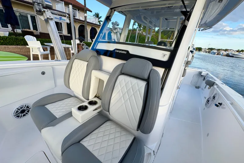  Yacht Photos Pics 2021 Everglades 335 Center Console boat with luxurious seating and waterfront view.