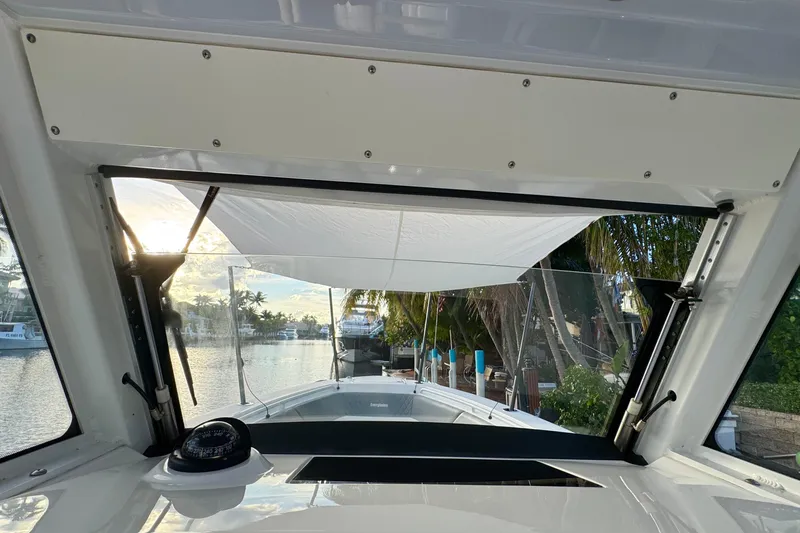  Yacht Photos Pics Interior view of 2021 Everglades 335 Center Console boat with scenic waterfront backdrop.