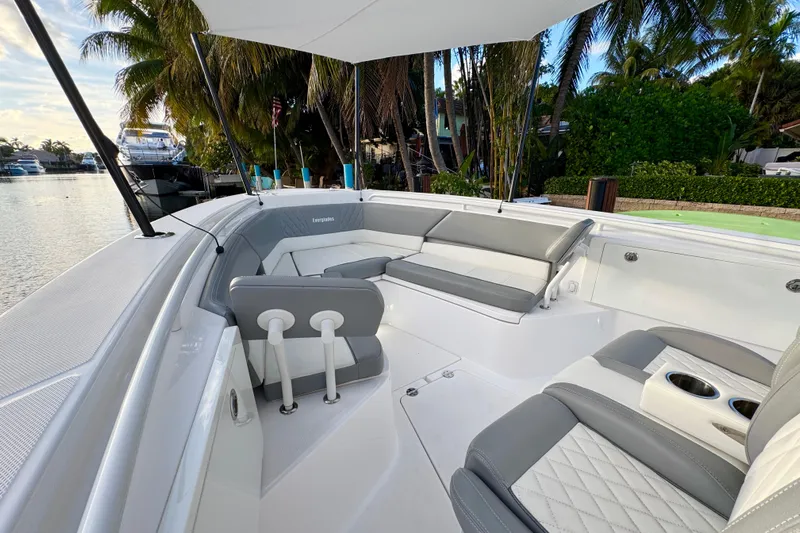  Yacht Photos Pics 2021 Everglades 335 Center Console boat with sleek seating, docked near palm trees.