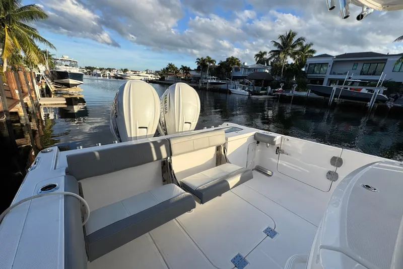  Yacht Photos Pics 2021 Everglades 335 Center Console boat docked in a scenic marina setting.
