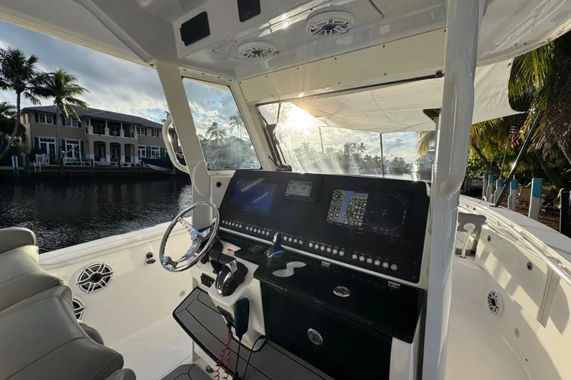  Yacht Photos Pics 2021 Everglades 335 Center Console boat interior with modern dashboard and waterfront view.