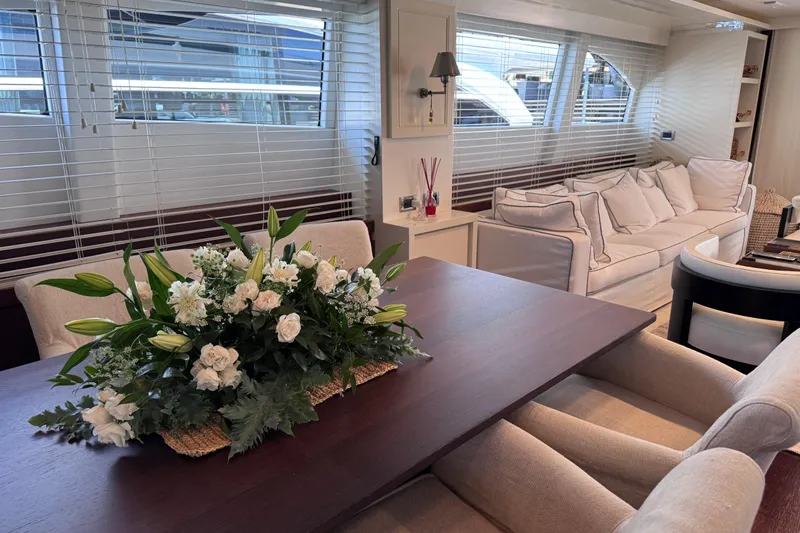  Yacht Photos Pics Luxurious interior of 2009 Canados 86 yacht with elegant floral centerpiece and plush seating.