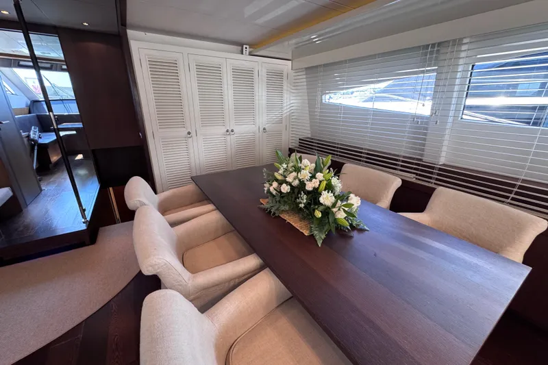  Yacht Photos Pics Luxurious dining area on 2009 Canados 86 yacht with elegant table and floral centerpiece.