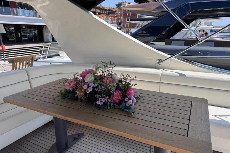  Yacht Photos Pics Luxurious 2009 Canados 86 yacht deck with elegant floral centerpiece on wooden table.
