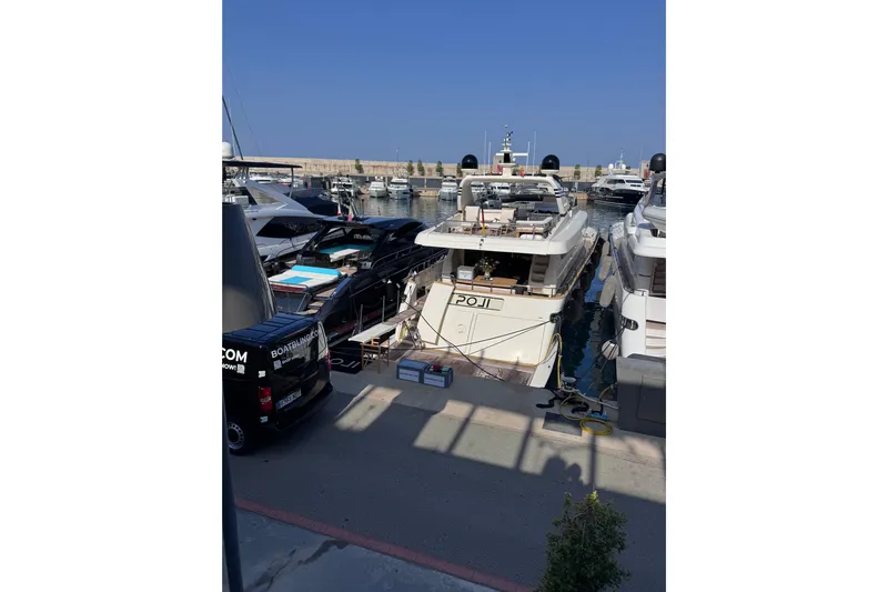  Yacht Photos Pics Luxury Canados 86 yacht docked in marina, 2009 model, surrounded by other boats.