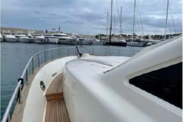  Yacht Photos Pics Luxury Canados 86 yacht from 2009 docked in a marina with other boats.