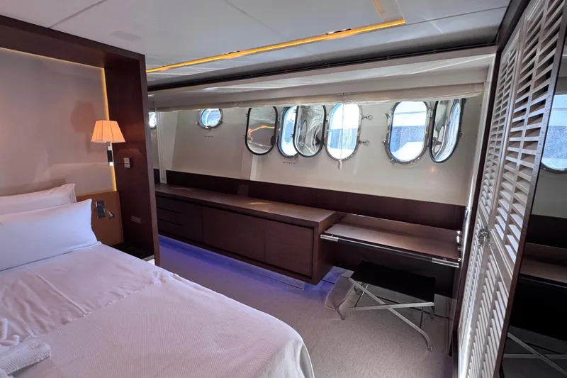  Yacht Photos Pics Luxurious bedroom interior of 2009 Canados 86 yacht with modern design and porthole windows.