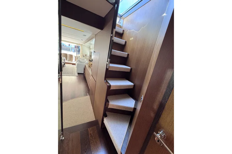  Yacht Photos Pics Interior of 2009 Canados 86 yacht featuring modern staircase and elegant design.