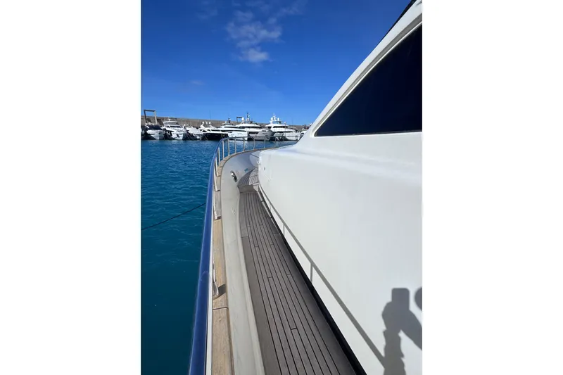  Yacht Photos Pics 2009 Canados 86 yacht docked in a marina under clear blue skies.