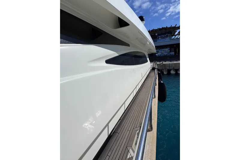  Yacht Photos Pics Side view of a 2009 Canados 86 yacht docked at a marina.