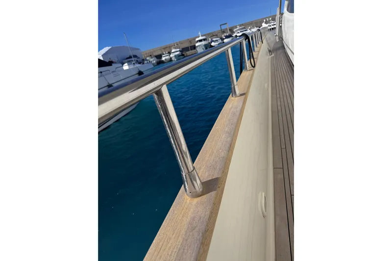  Yacht Photos Pics Side view of 2009 Canados 86 yacht railing with marina background.