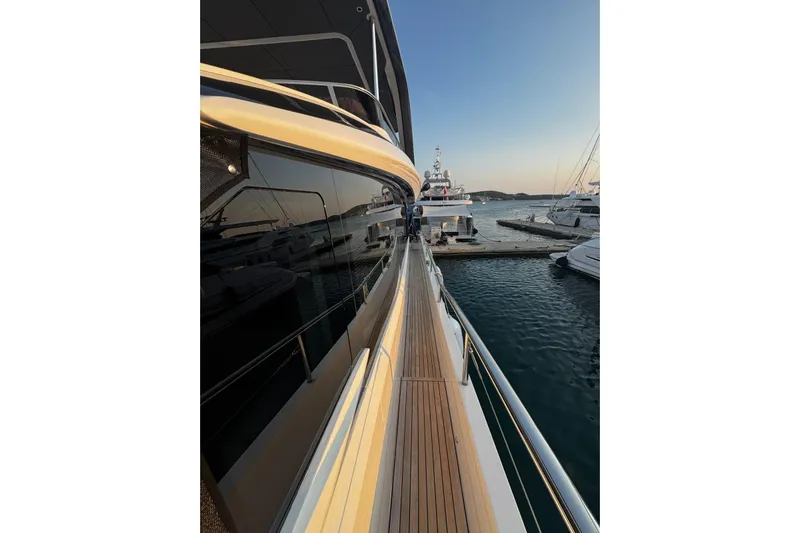 Solomon Yacht Photos Pics 2025 Princess Y72 yacht docked at marina during sunset, showcasing sleek design and luxury.