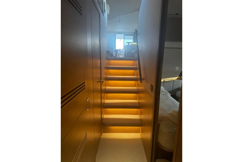 Solomon Yacht Photos Pics Luxurious interior staircase of 2025 Princess Y72 yacht, featuring elegant lighting and modern design.