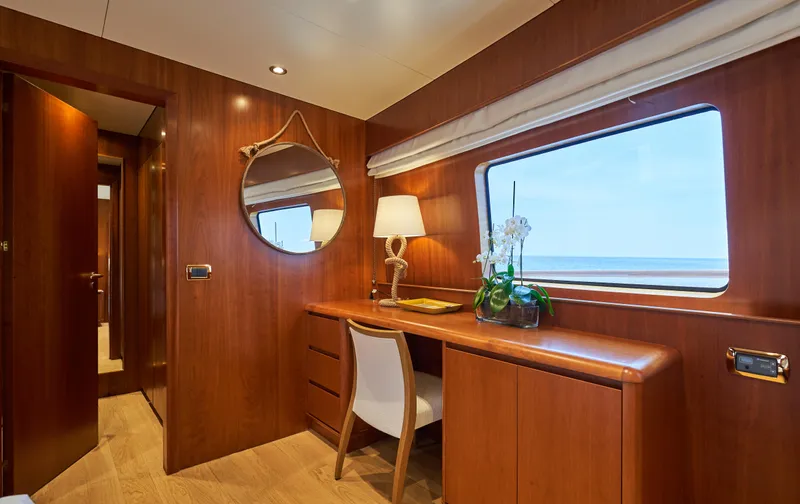 L'instant IV Yacht Photos Pics Luxurious interior of 2009 Castagnola Navetta 33 yacht with wooden desk and ocean view.