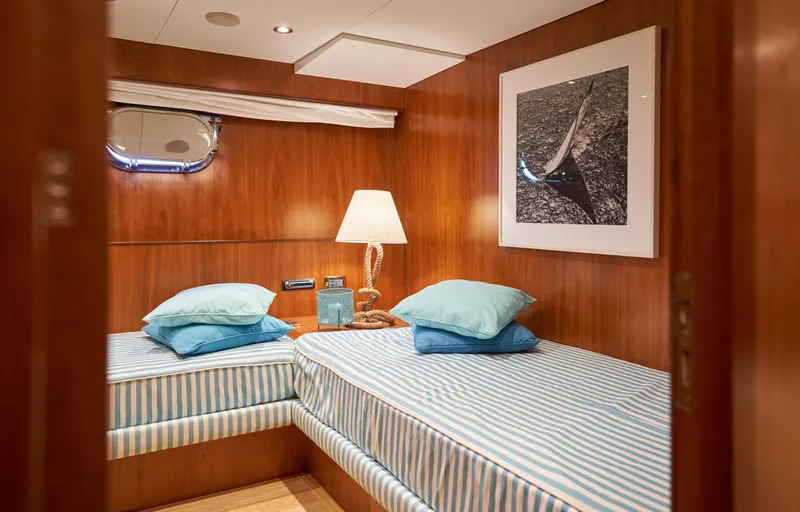 L'instant IV Yacht Photos Pics Twin cabin interior of 2009 Castagnola Navetta 33 yacht with striped bedding.