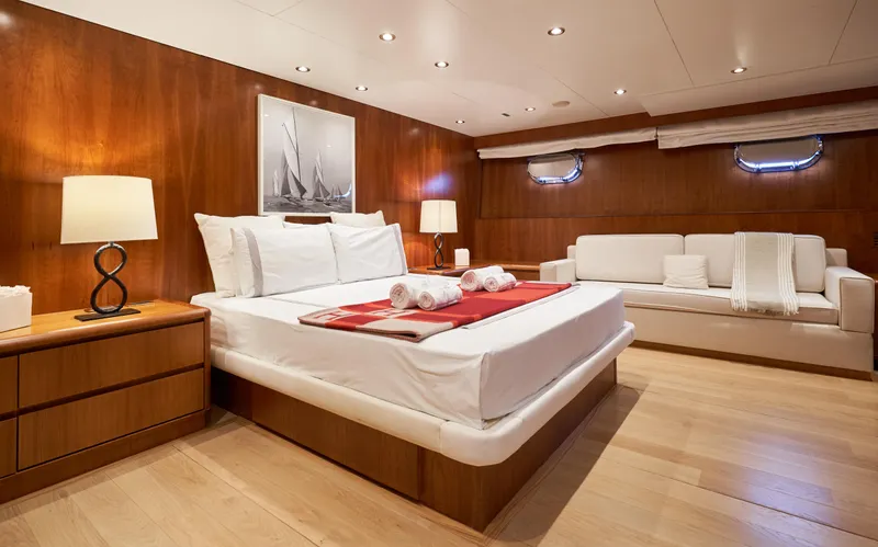 L'instant IV Yacht Photos Pics Luxurious bedroom interior of 2009 Castagnola Navetta 33 yacht with wooden finishes.