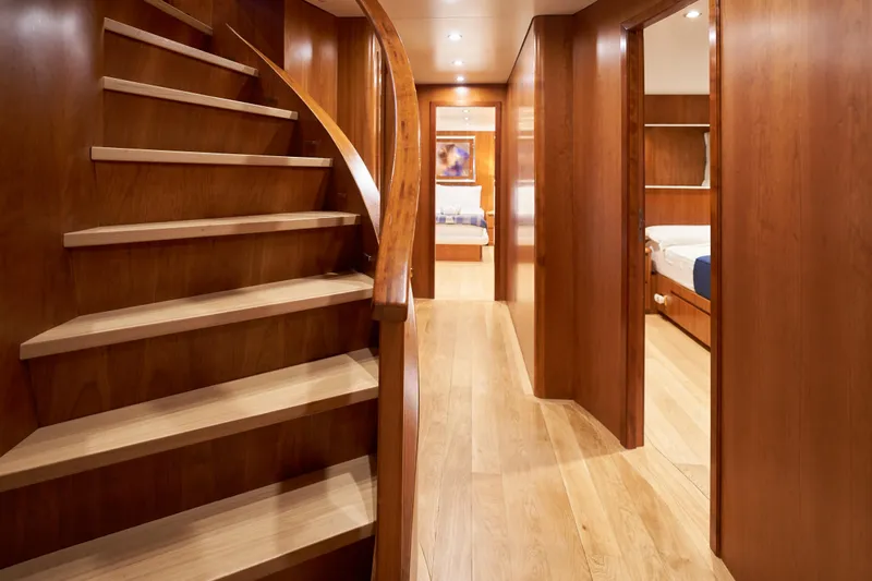 L'instant IV Yacht Photos Pics Luxurious wooden interior of 2009 Castagnola Navetta 33 yacht with curved staircase.