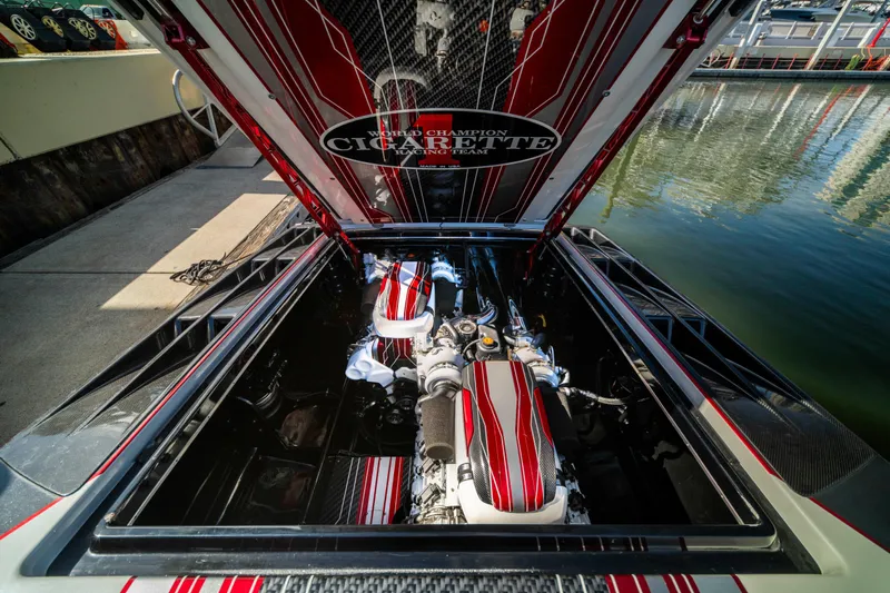  Yacht Photos Pics 2020 Cigarette 515 boat engine compartment with red and white detailing at a marina.