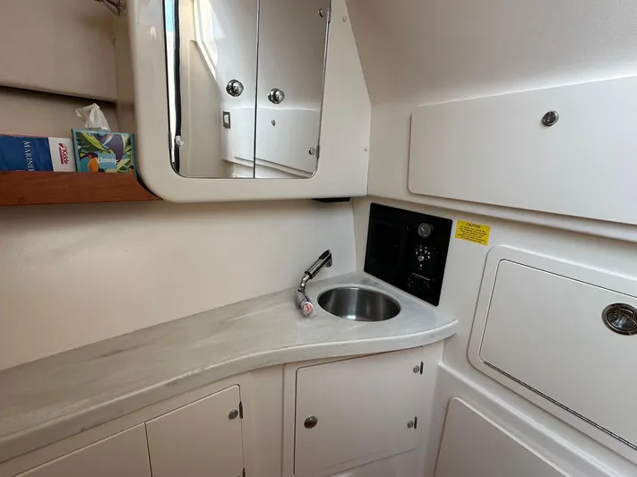  Yacht Photos Pics 2024 Grady-White Freedom 335 boat interior with sink and mirror.