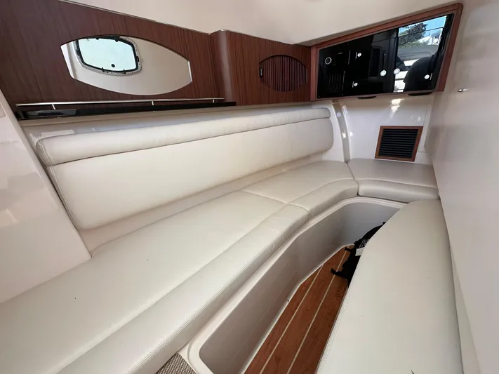  Yacht Photos Pics 2024 Grady-White Freedom 335 cabin interior with white seating and wood accents.