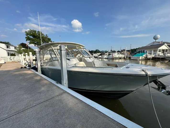  Yacht Photos Pics 2024 Grady-White Freedom 335 boat docked at a marina under a clear blue sky.