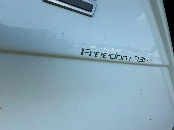  Yacht Photos Pics 2024 Grady-White Freedom 335 boat nameplate on white hull.