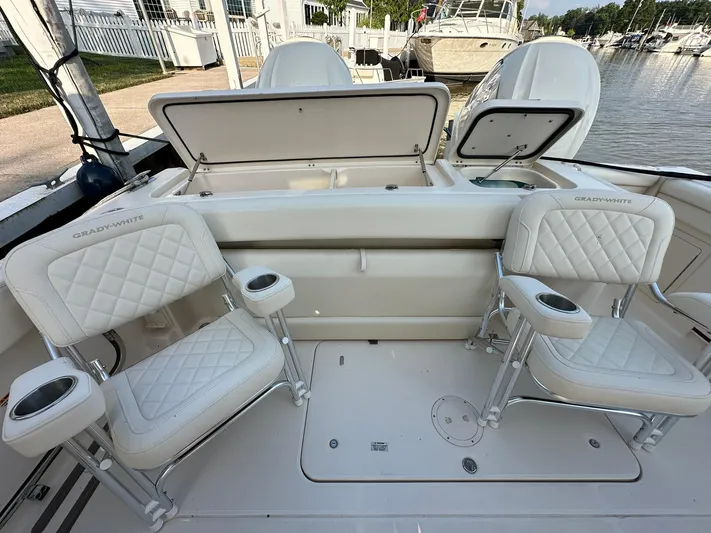  Yacht Photos Pics 2024 Grady-White Freedom 335 boat interior with cushioned seating and storage compartments.