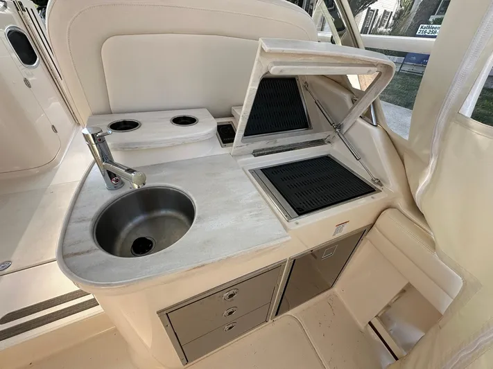  Yacht Photos Pics 2024 Grady-White Freedom 335 boat interior with sink and grill station.